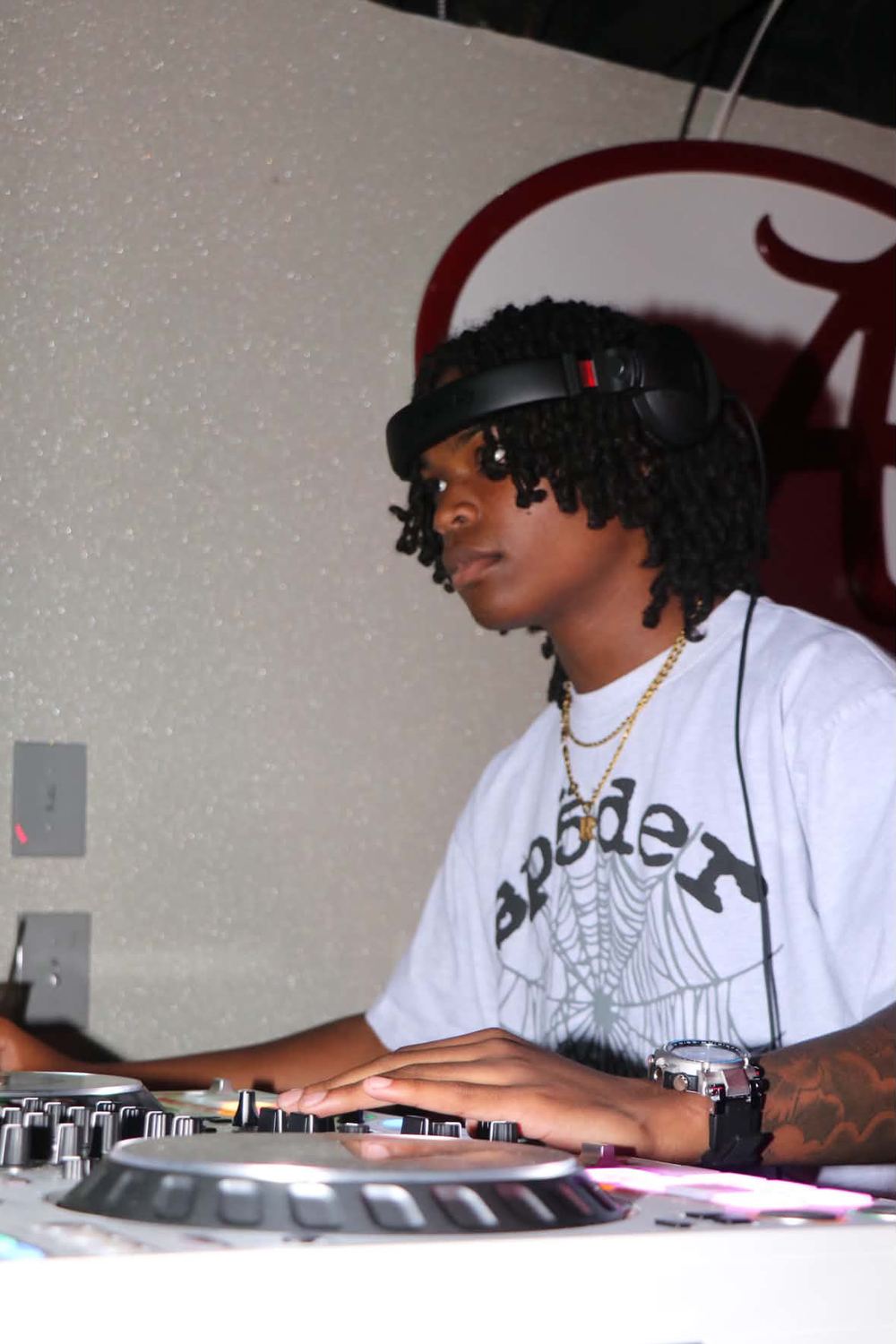 DJ Reese in the booth wearing headphones