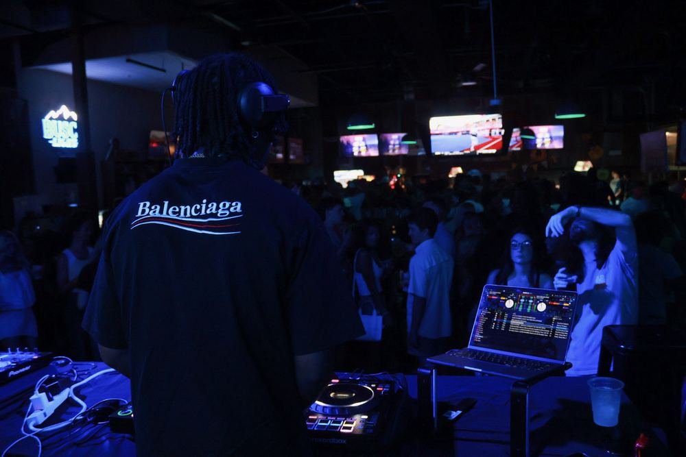 DJ Reese playing to a packed bar crowd